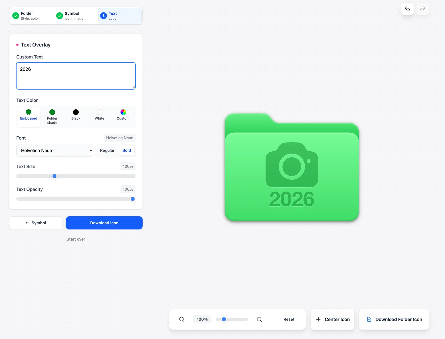 The Text step with 2026 typed into the Custom Text field and the Embossed color selected. The preview shows the green camera folder with 2026 embossed below the camera.